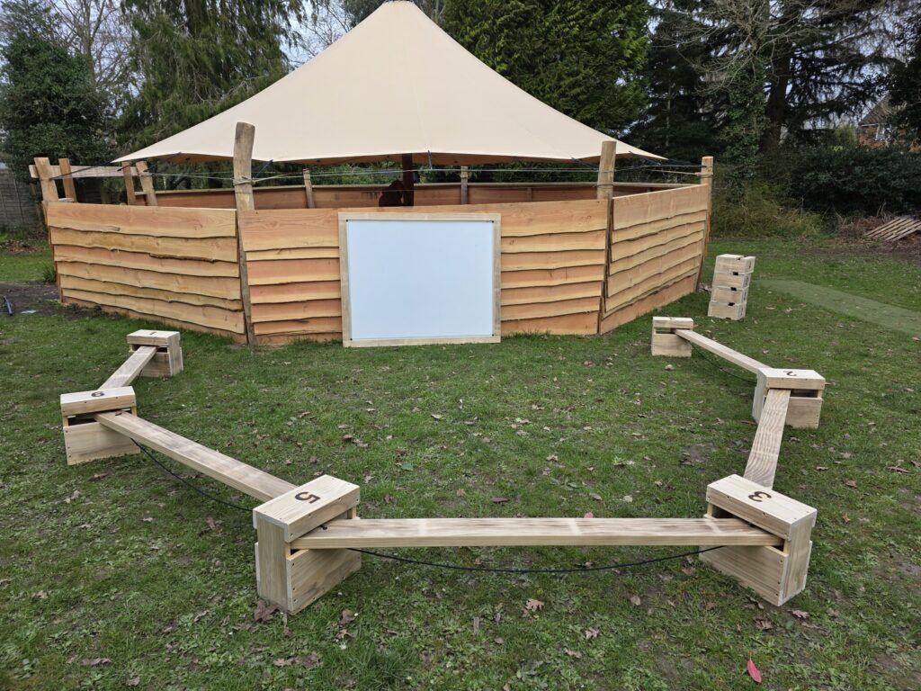 Outdoor classroom with seating and whiteboard